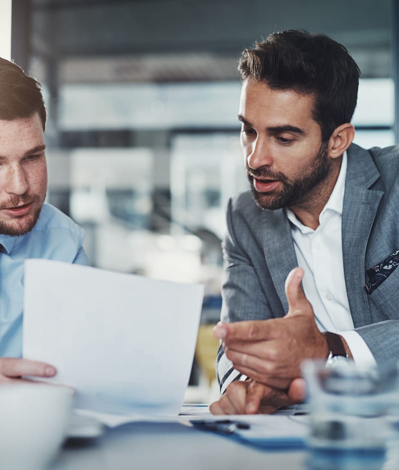 A business man and a lawyer review a report