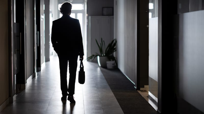 A charity trustee leaves a building after disqualification