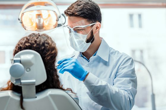A dentist treating a patient in their dental practice
