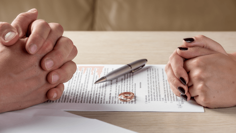 A divorcing couple sits across the table