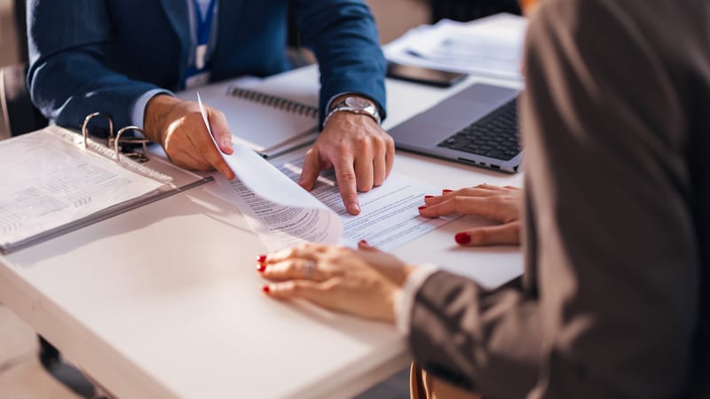 A lawyer explains a legal document to a client