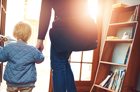 A parent and child leave the house