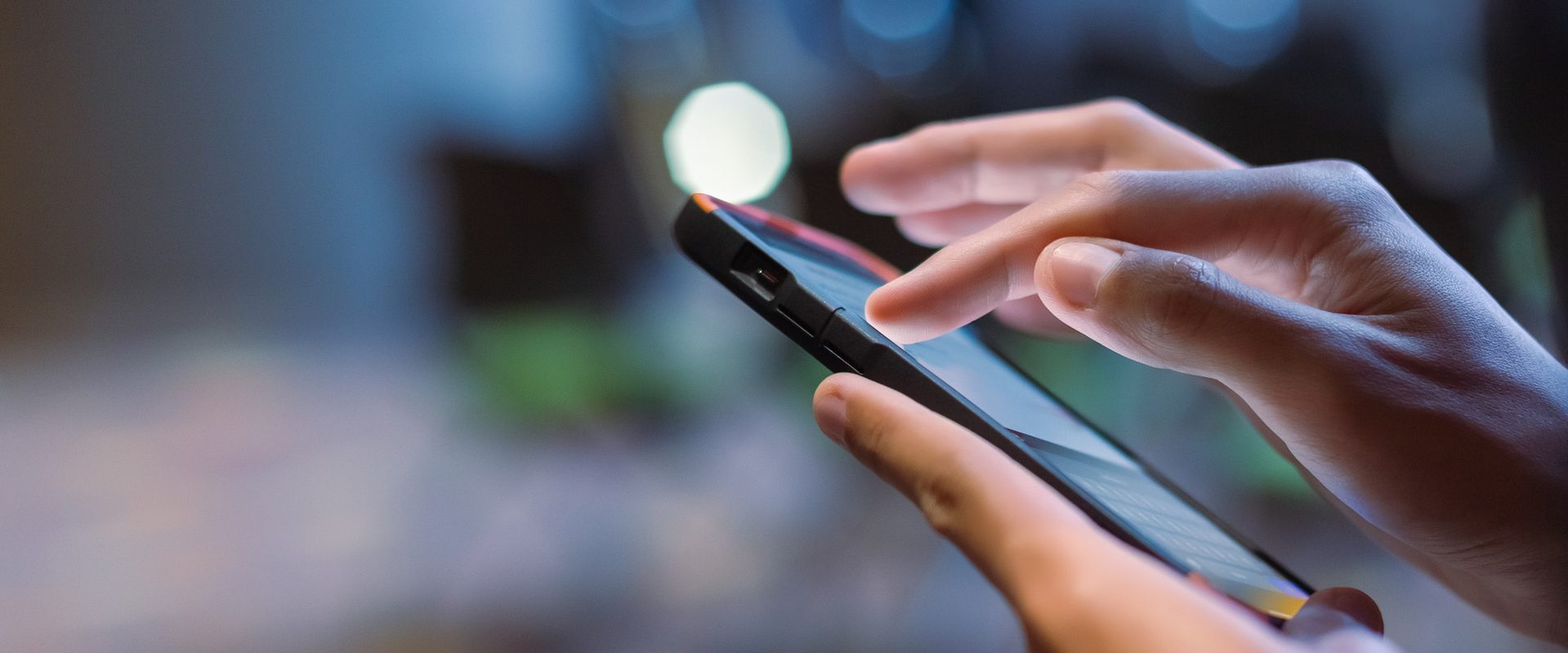 A victim of online abuse uses a phone