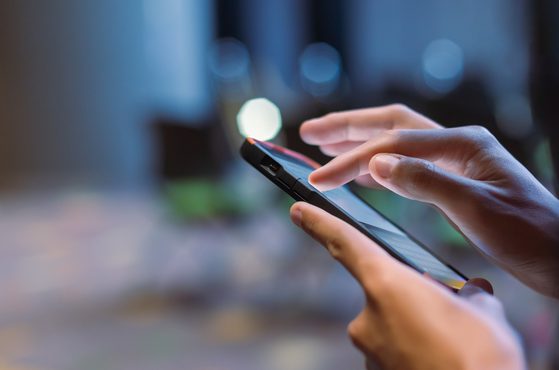 A victim of online abuse uses a phone