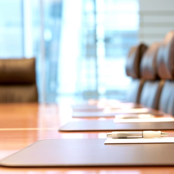 Boardroom concept smart chairs and pens laid out on table