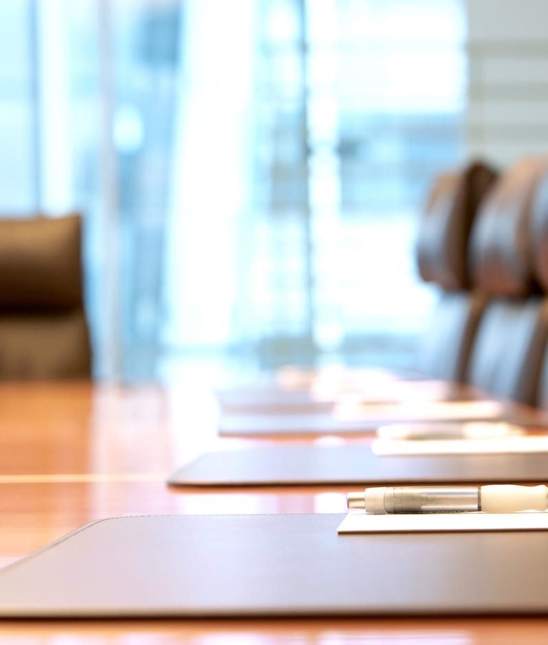 Boardroom concept smart chairs and pens laid out on table