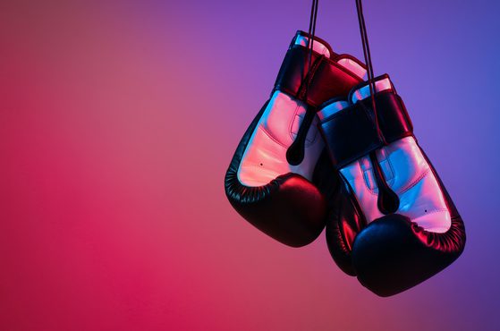 Boxing gloves hanging down with red and blue background