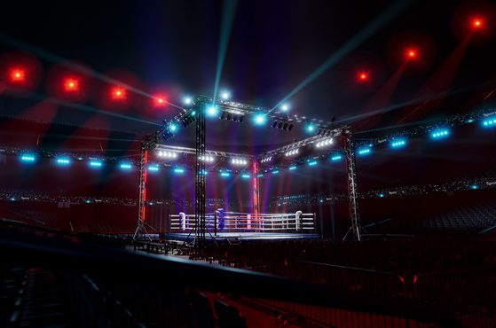 Boxing ring lit up in huge arena