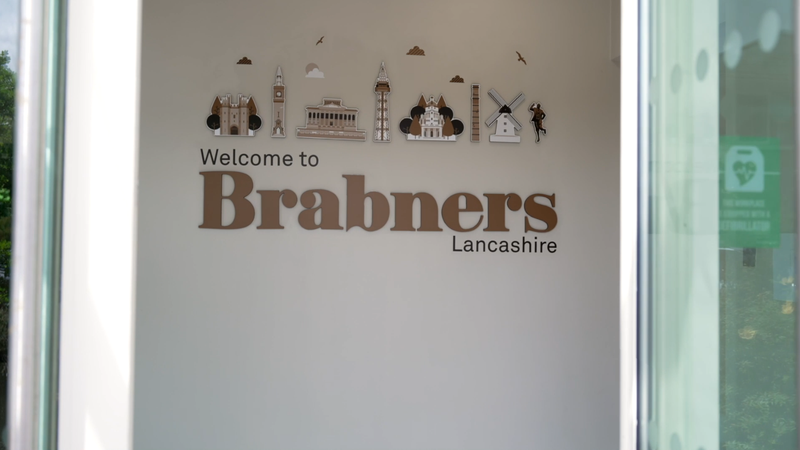Welcome to Brabners Lancashire with illustrated landmarks and a windmill on a white wall.