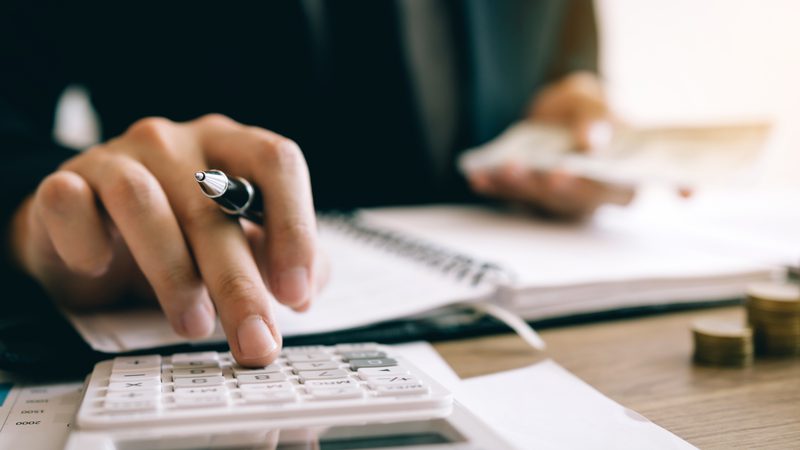 Businessman using calculator insolvency concept