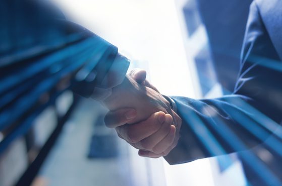 Businessmen shaking hands corporate dealmaking concept