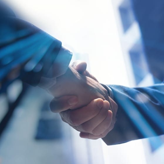 Businessmen shaking hands corporate dealmaking concept