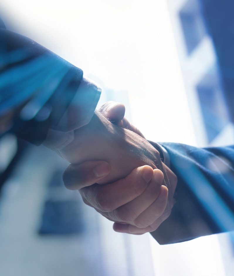 Businessmen shaking hands corporate dealmaking concept