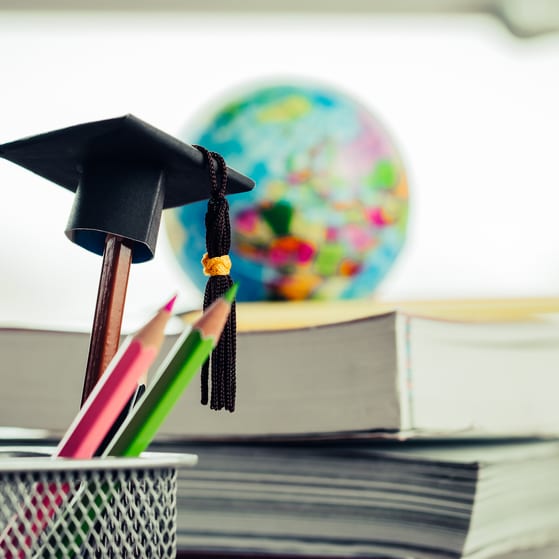 Classroom stack of books and pencil pot