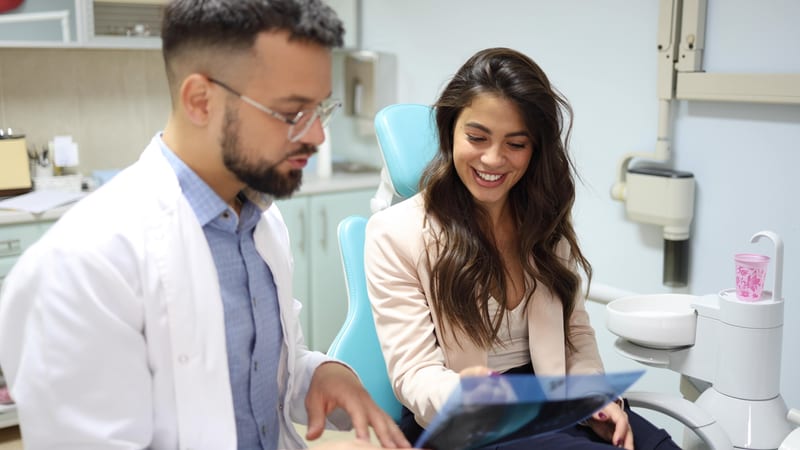 Dental patient reviewing x rays
