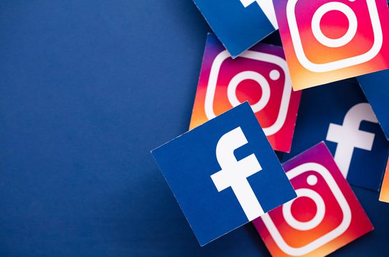 Facebook and instagram icons in boxes on blue background