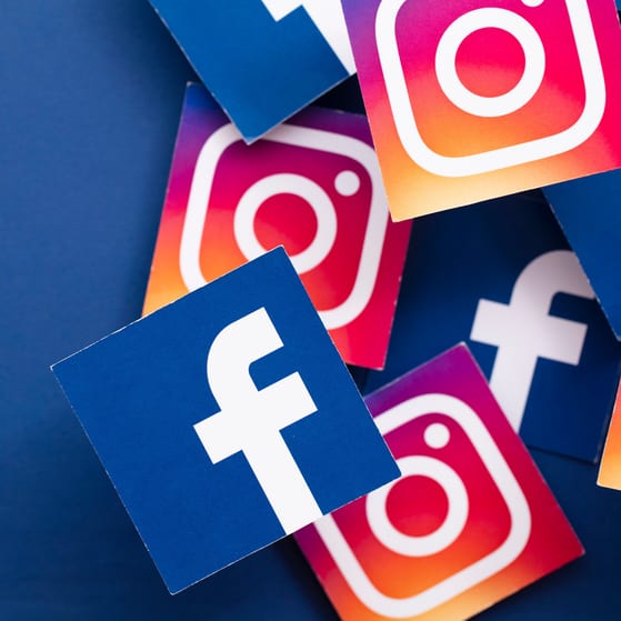 Facebook and instagram icons in boxes on blue background