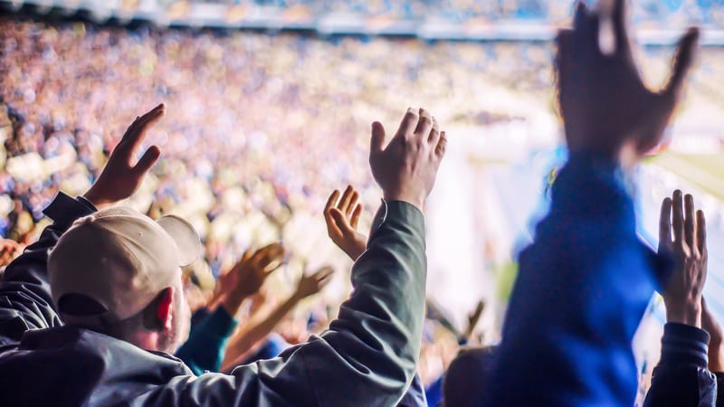 Football fans in stadium chanting