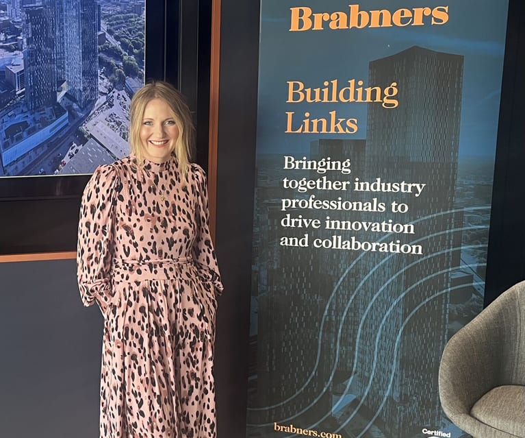 Jennie Jones at Brabners Building Links event with roller banner