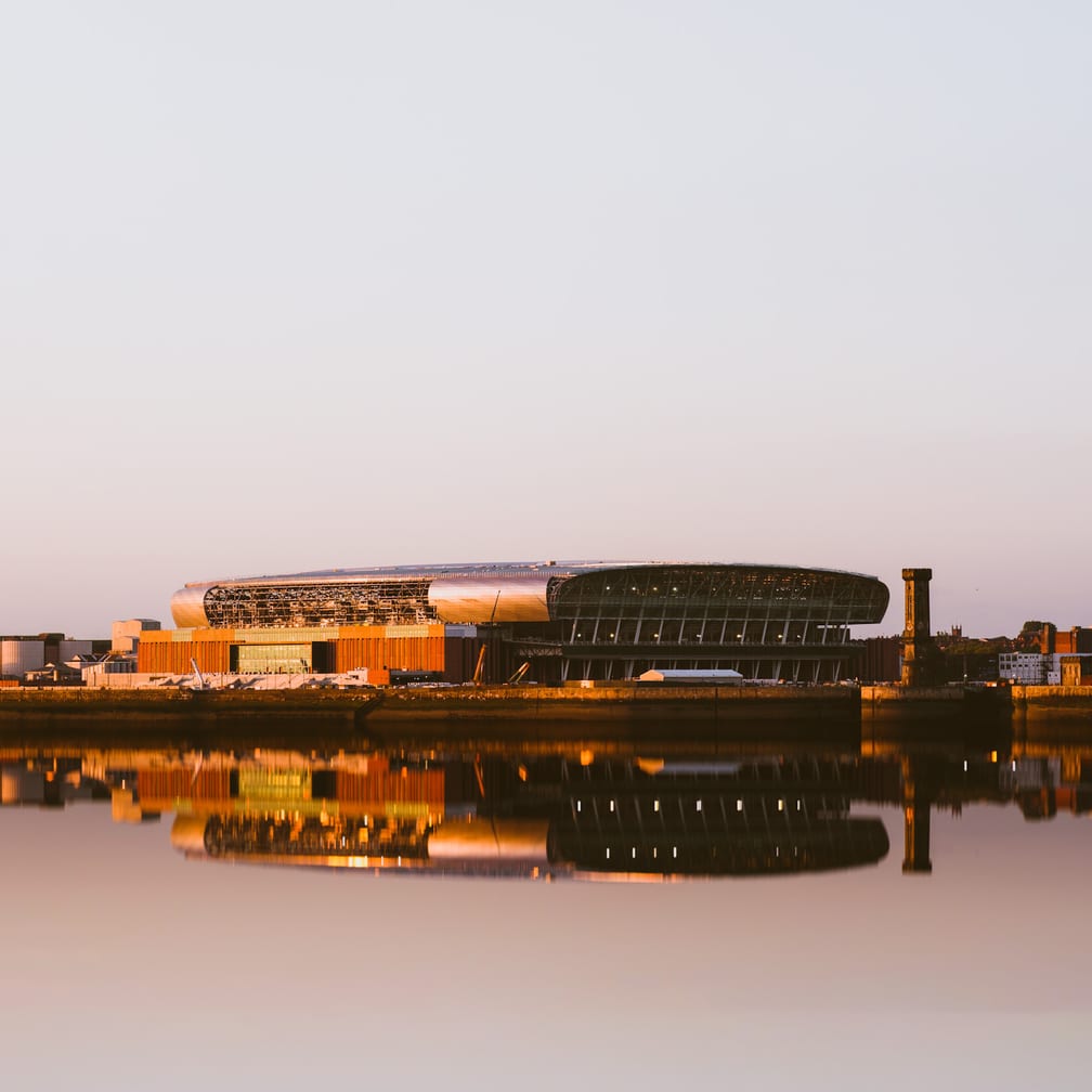 Liverpool UK June 2024 Everton football club new bramley moore dock premier league stadium during sunset with reflection in mersey river