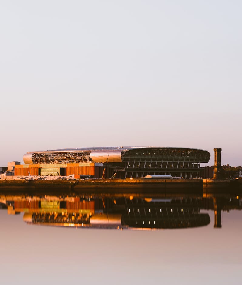 Liverpool UK June 2024 Everton football club new bramley moore dock premier league stadium during sunset with reflection in mersey river