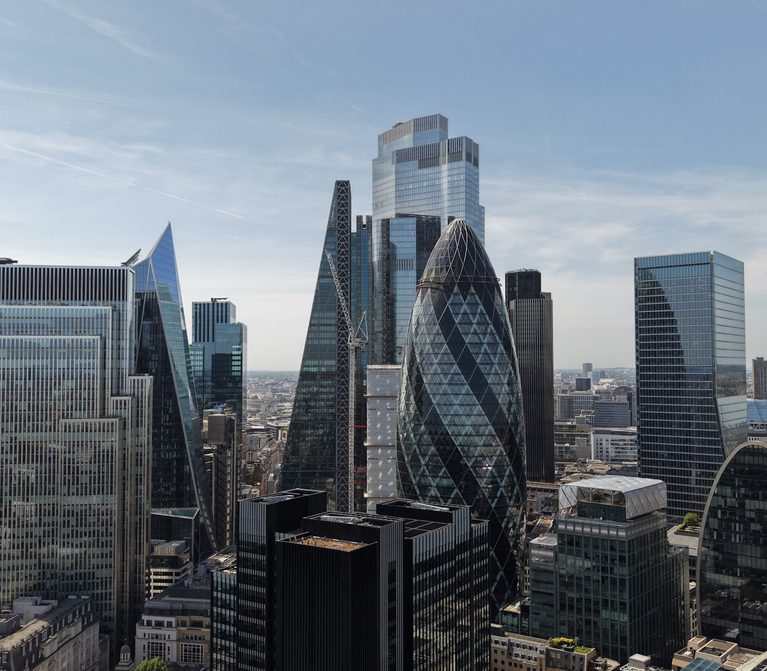 London skyline featuring modern glass skyscrapers, including the Gherkin and Walkie-Talkie, beneath a clear blue sky.