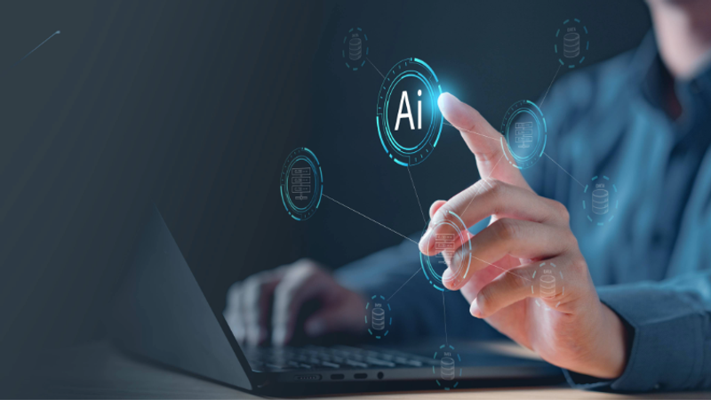 Person operating a laptop with futuristic AI holograms, a glowing circular AI icon and orbiting data nodes against a dark tech background.