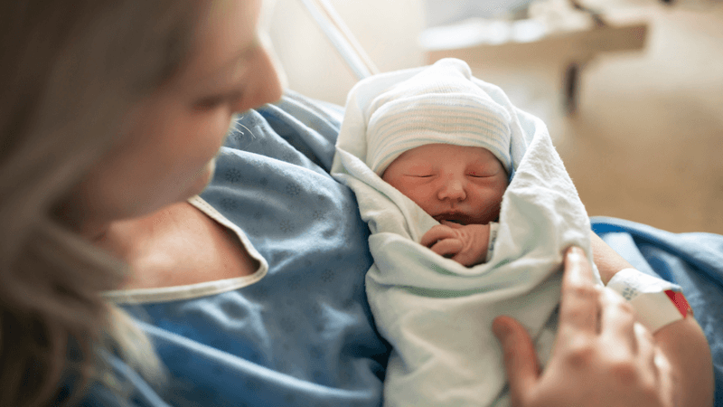 Mother and baby receiving neonatal care