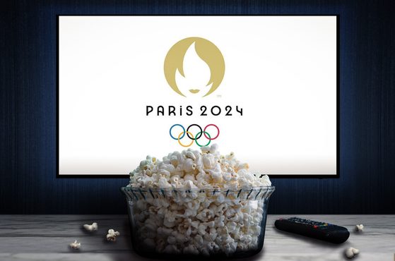 Paris 2024 Olympic games logo on television screen behind bowl of popcorn