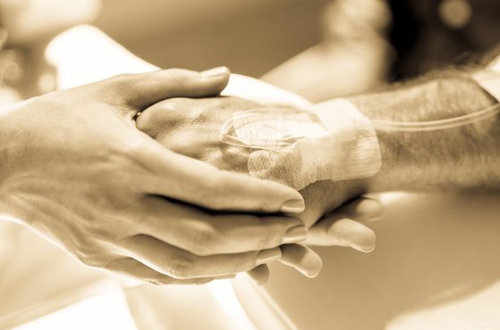 Prolonged chemotherapy patient doctor holding hand drip