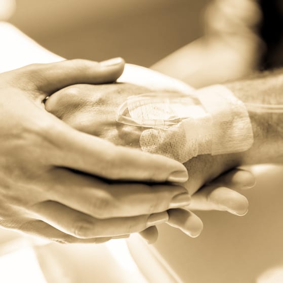 Prolonged chemotherapy patient doctor holding hand drip