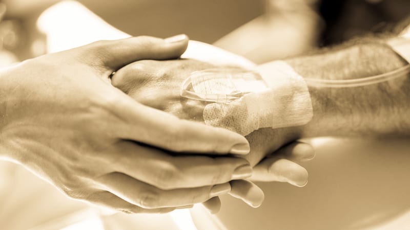 Prolonged chemotherapy patient doctor holding hand drip