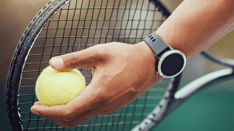 Tennis player holds a ball to a racket