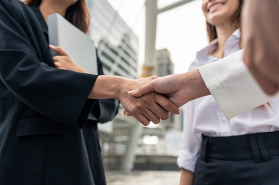 Two businesswomen shaking hands