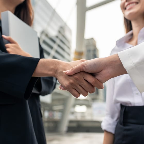 Two businesswomen shaking hands