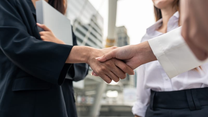 Two businesswomen shaking hands