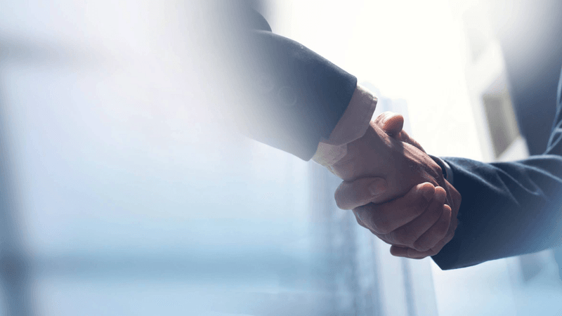 handshake between two business executives