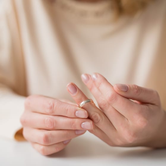 Woman taking off wedding ring