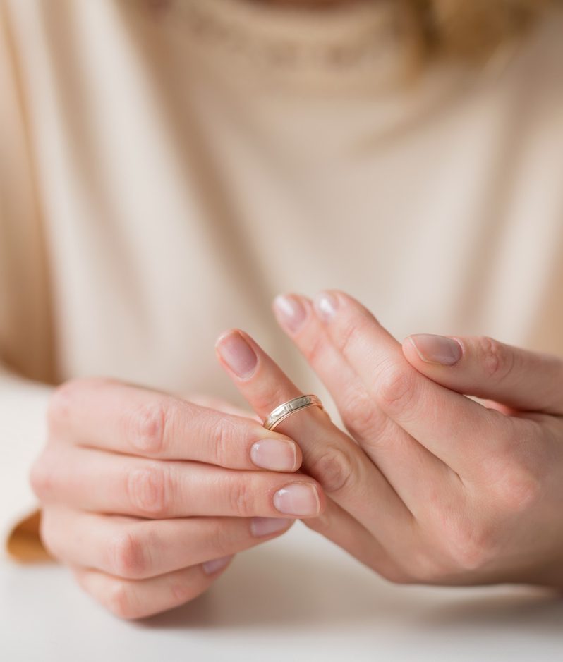 Woman taking off wedding ring