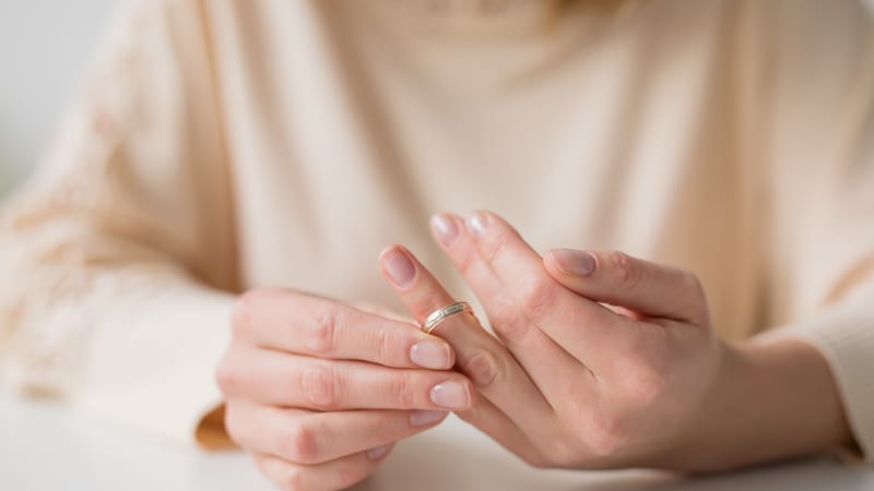 Woman taking off wedding ring