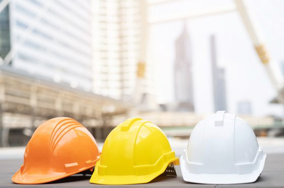 Coloured hard hats construction setting