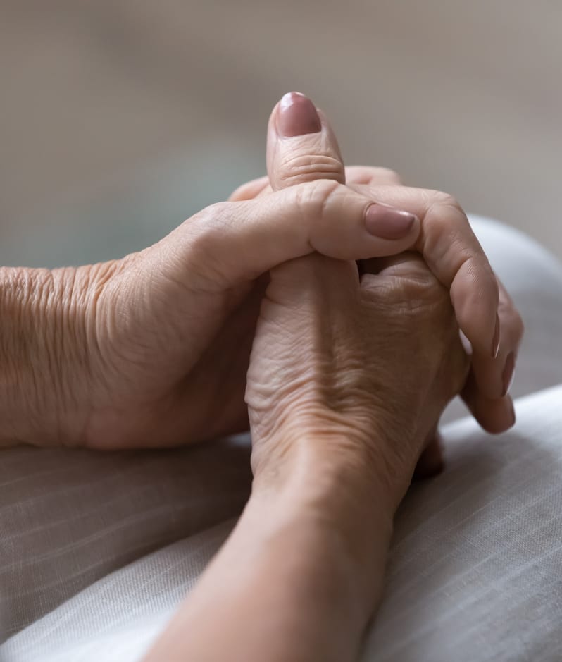 Elderly woman hands clasped