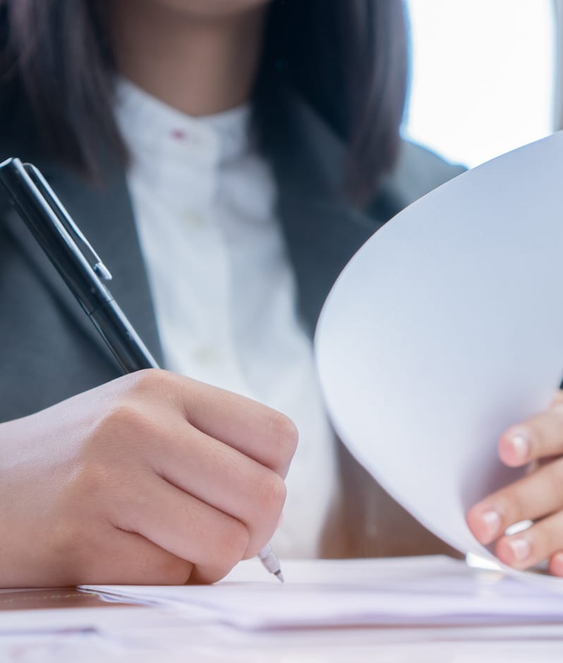 Female businessperson signing papers