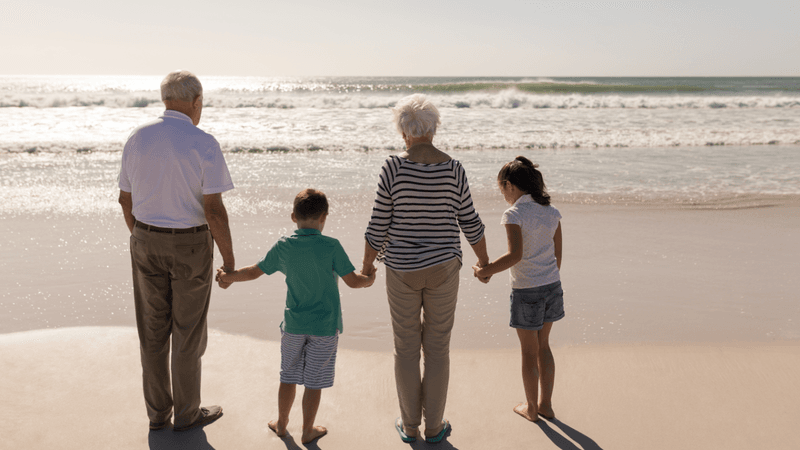 Grandparents on the beach with grandchildren