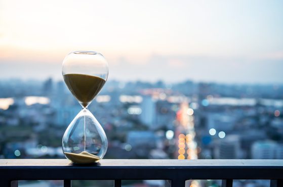 Hourglass with city backdrop