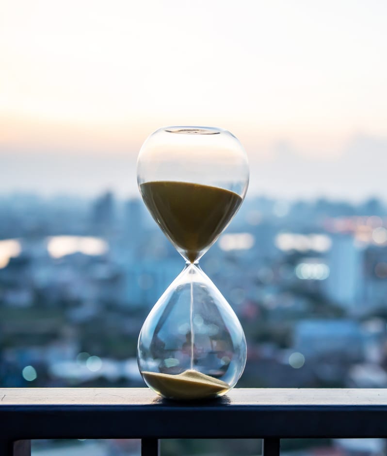 Hourglass with city backdrop