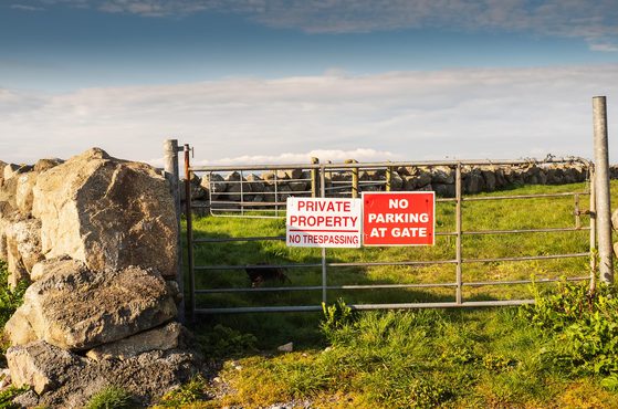 No trespassing sign on field gate