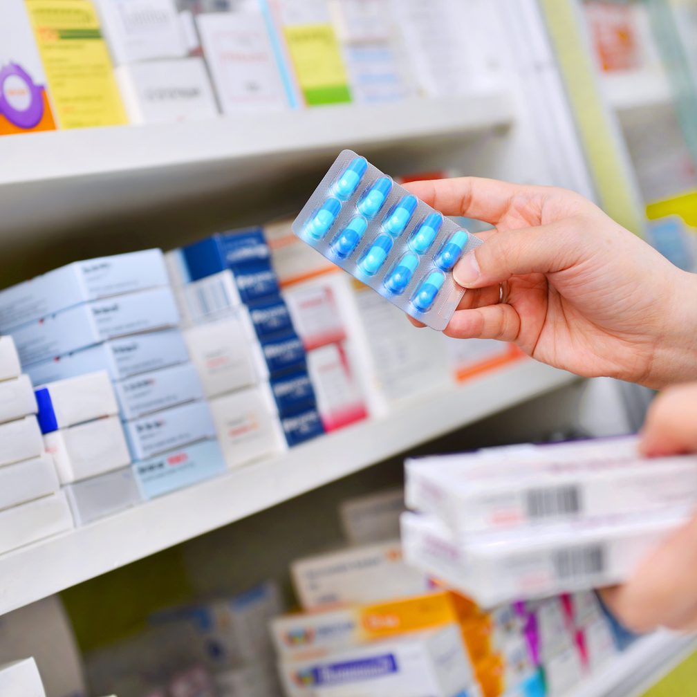 Pharmacy pharmacist getting pills off shelf