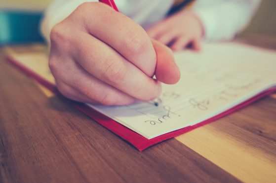 School girl writing in note book