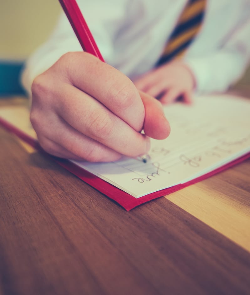 School girl writing in note book